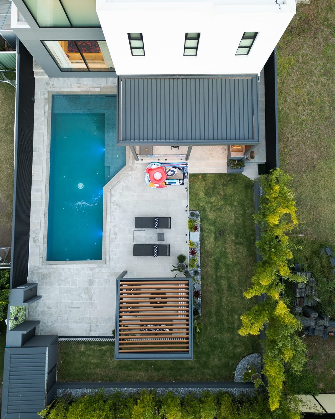 Aerial view of a home featuring a Louvretec opening louvre roof and retractable louvre roof installed over two outdoor living areas