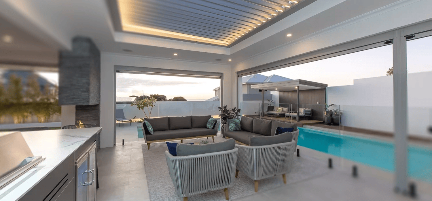 Modern outdoor living area with pool and Louvretec louvre roof for adjustable shade and comfort.