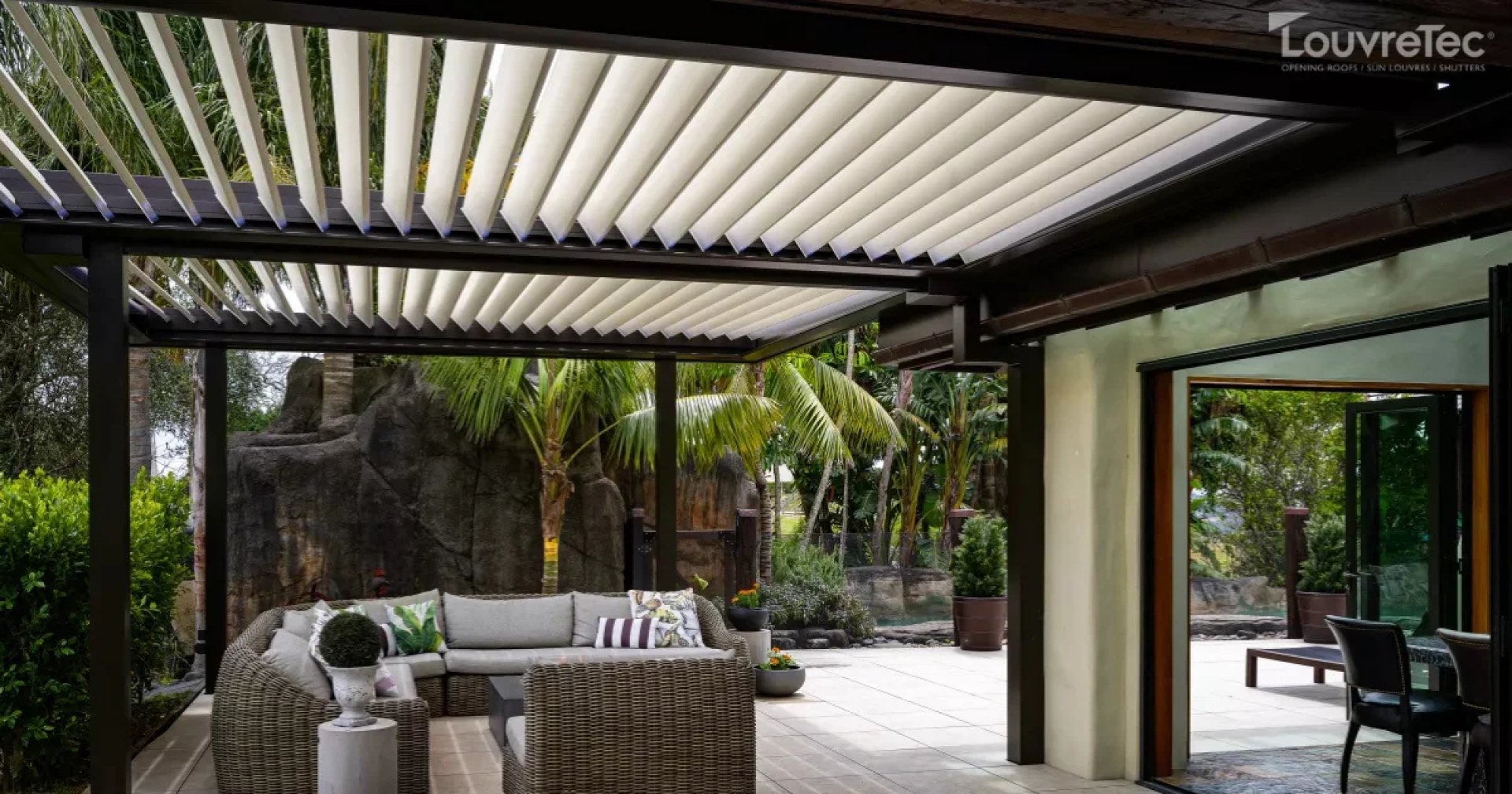 Modern residential patio with a Louvretec opening roof and comfortable outdoor furniture.