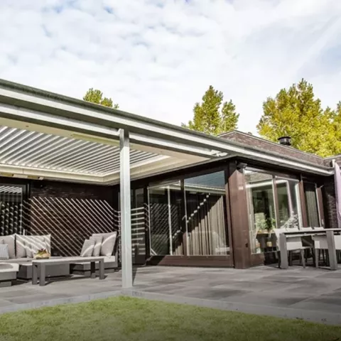A patio featuring a covered area with comfortable patio furniture arranged for relaxation and outdoor dining.